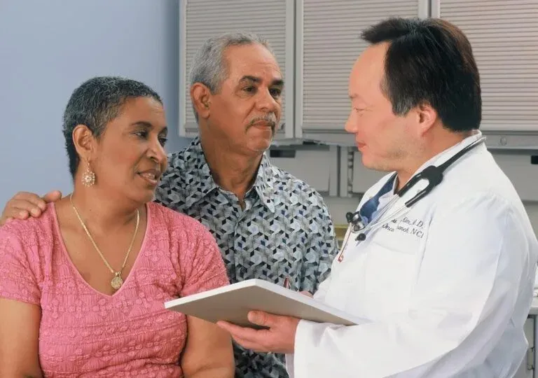 Doctor speaking with an older couple about pelvic health concerns